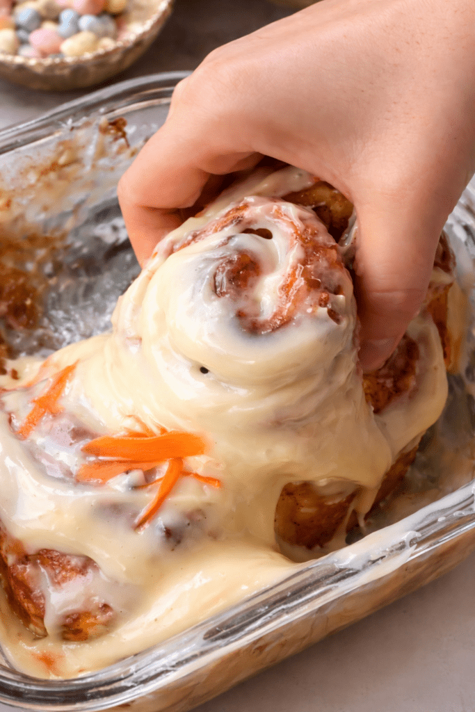  grabbing a single carrot cake cinnamon roll