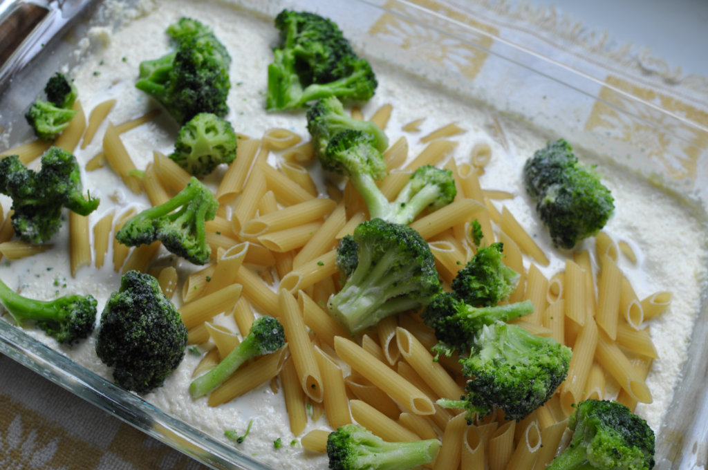 adding broccoli to the alfredo and pasta